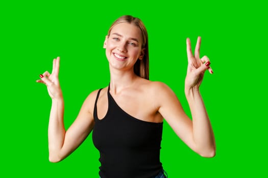 Woman in Black Tank Top Making Peace Sign in studio