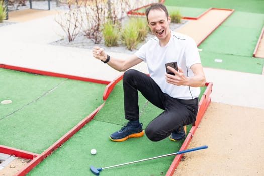 Touch screen in hand, tablet on golf club. smartphone with a sports betting application. High quality photo