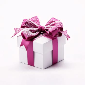 White gift with pink bow presumed snow, white background. Gifts as a day symbol of present and love. A time of falling in love and love.