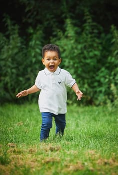 Tilst, Denmark, 12th of August, 2023: Cute black boy playing in the park