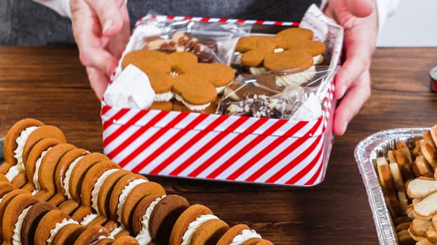 Lovingly homemade gingerbread and sugar cookies, half-dipped in rich chocolate, nestled in decorative Christmas tin boxes perfect for seasonal gifting.