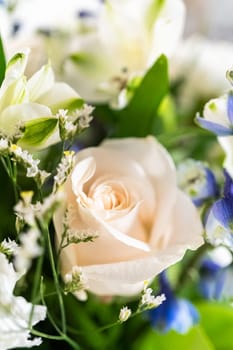 A stunning bouquet featuring fresh white roses and assorted flowers gracefully arranged in a vase, exuding timeless beauty.