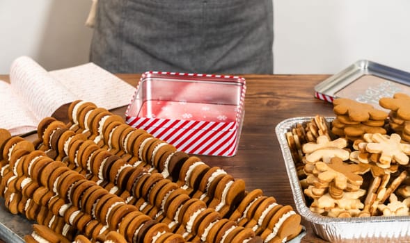 Lovingly homemade gingerbread and sugar cookies, half-dipped in rich chocolate, nestled in decorative Christmas tin boxes perfect for seasonal gifting.