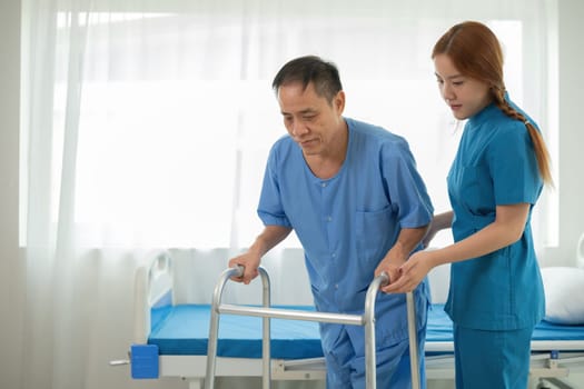 A sick caregiver or young nurse is helping a patient who is rehabilitating with physical therapy at the hospital..