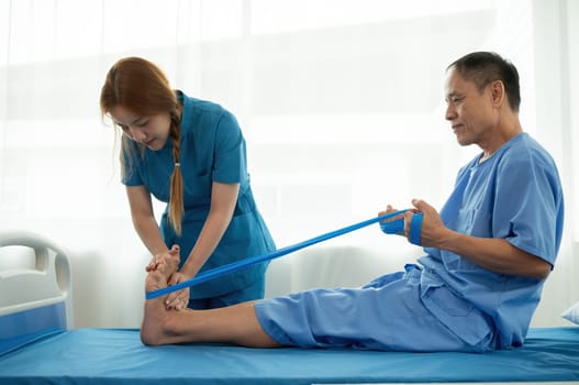 A sick caregiver or young nurse is helping a patient who is rehabilitating with physical therapy at the hospital..