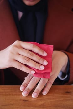 women disinfecting his hands with a wet wipe