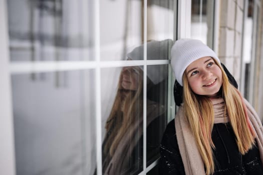 Portrait of a teenage girl at the windows of her home