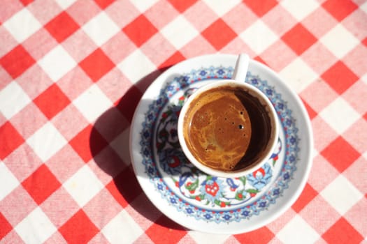 a cup of turkish coffee on table .