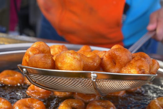 Traditional fried sweets lokma in sugar syrup.