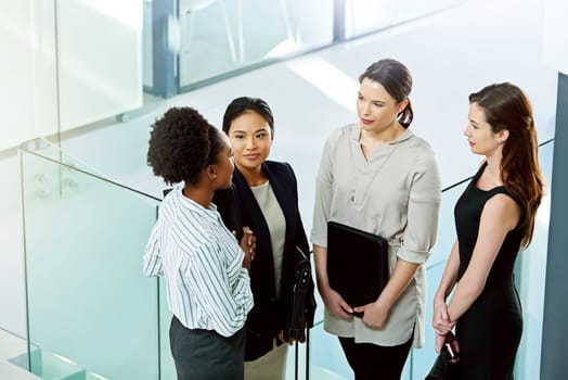 Top view, collaboration and communication in corporate meeting for finance report, diversity and strategy while brainstorming. Teamwork, business women and discuss project in office, idea or planning.