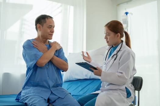 A female doctor is examining the body and taking notes on a sick person in a hospital examination room..