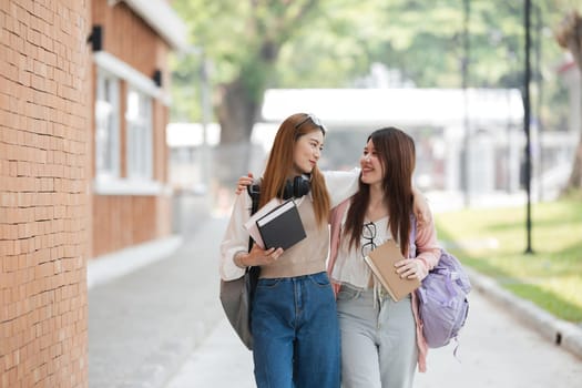 Group of young Asian college students are studying together in university. Students outdoors. Education concept..