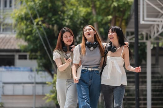 Group of happy students walking along the corridor at college.