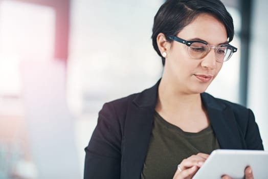 Business woman, research and browsing with tablet for online news, data or corporate statistics at office. Female person or employee scrolling and reading on technology for review, feedback or report.