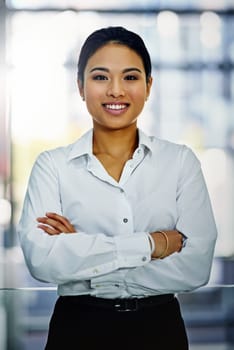Asian businesswoman, portrait and office with arms crossed, smile and confidence for goals. Corporate lawyer, professional law firm and expert attorney for success, management and startup workspace.