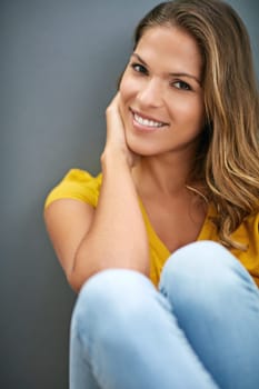 Wall, peace and woman on floor, portrait and relax for weekend, Gen z and smile for fashion in house. Grey background, happiness and girl in apartment, cheerful and comfortable on ground of home.
