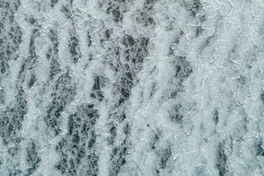 Aerial top down view of ice surface. Frozen sea surface texture