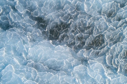 Aerial top down view of ice surface. Frozen sea surface texture