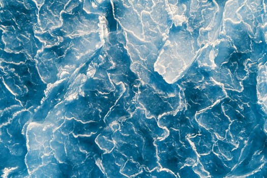 Aerial top down view of ice surface. Frozen sea surface texture