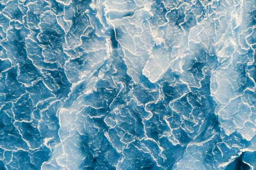 Aerial top down view of ice surface. Frozen sea surface texture
