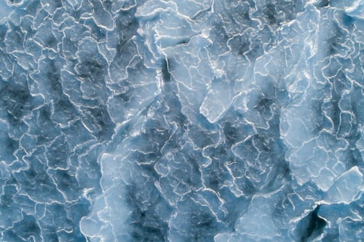 Aerial top down view of ice surface. Frozen sea surface texture