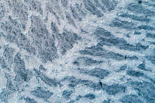 Aerial top down view of ice surface. Frozen sea surface texture