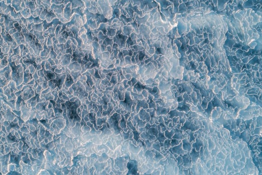 Aerial top down view of ice surface. Frozen sea surface texture