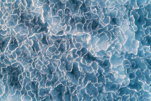 Aerial top down view of ice surface. Frozen sea surface texture