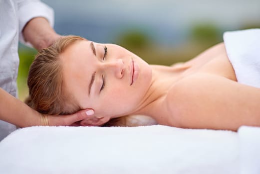 Woman, spa and relax with head massage with comfort for stress relief with beauty or health. Calm, zen and resting with masseuse hands for wellbeing on holiday for bliss with professional for peace.