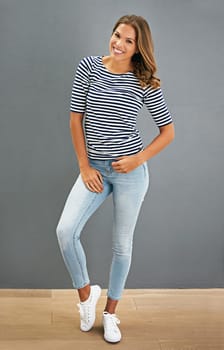 Fashion, smile and portrait of woman on a wall isolated on a gray background, backdrop or space. Confidence, style and happy model in casual clothes, jeans and young student in shirt in Australia.