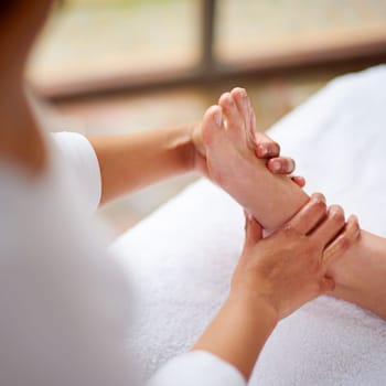 Foot, hands and massage closeup with spa for treatment, beauty and skincare at luxury resort for wellness. Pedicure, cosmetics and people for physical therapy with healing for self care and relief.