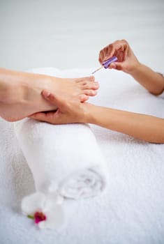 Foot, hands and nail polish for pedicure with treatment, skin and dermatology with makeup at spa. Beauty, wellness and people with cosmetics product for color, self care and cosmetology at resort.
