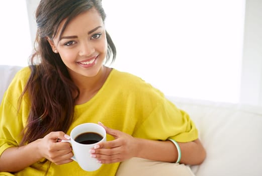 Woman, portrait and coffee in living room for relax, happiness and sofa in apartment. young female person, hot drink and rest indoors at home for self care, enjoyment and beverage for stress relief.