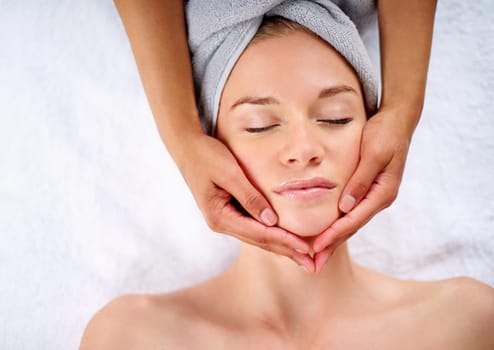 Woman, hands and facial massage or pamper treatment, cosmetics and beauty therapy. Female person, masseuse and serene or dermatology, skin care detox and above at spa for peace or zen and healing.