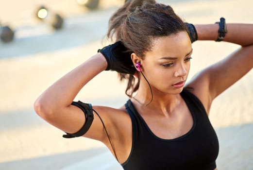 Woman, music and sit up for fitness, exercise and listening to podcast for endurance and inspiration outdoor. Young sports person with audio and thinking of body goal, health and workout or training.