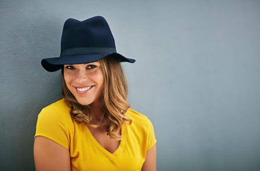 Woman, smile and portrait by gray background with hat, fashion inspiration and mockup for marketing. Happy, confidence and face of gen z person by dark wall with advertising space, fedora and style.