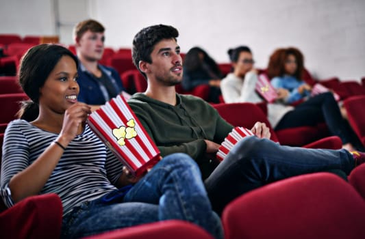 Movie, date and couple in cinema at night with popcorn to relax and watch in theatre with happiness. Film, experience and people in audience enjoy funny comedy, drama performance or eating snack food.