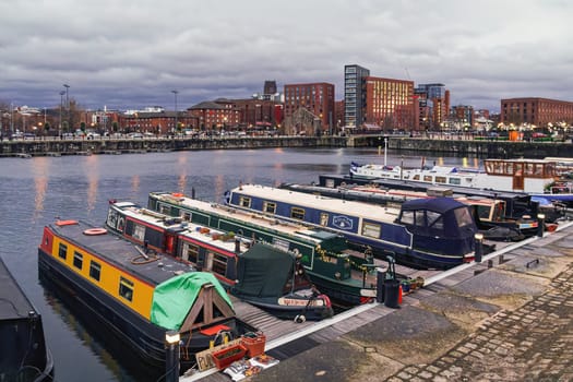 Liverpool, UK - February 21 2020: Moored narrowboats in the evening at Salthouse Dock.