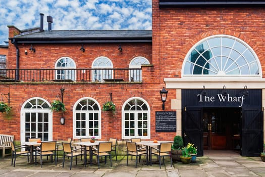 Manchester, UK - February 22 2020: The Wharf pub facade with outdoor seating in the Castlefield area.