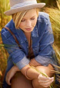 Woman, wheat field and countryside relax in summer or holiday vacation in meadow, calm or environment. Female person, grass and outdoor nature in New Zealand with sunshine, wellness or wilderness.