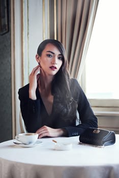 Portrait coffee and woman with cigarette, cafe or luxury with mob wife, elegant lady or gangster. Face, person or vintage fashion with crime boss, rich or criminal with confidence or hotel with mafia.