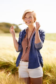 Woman, wheat field and grass environment in countryside for travel holiday or rural area, nature or sustainability. Female person, happiness and meadow location in New Zealand, explore or journey.