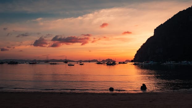 Beautiful sunset with silhouettes of philippine boats in El Nido, Palawan island, Philippines