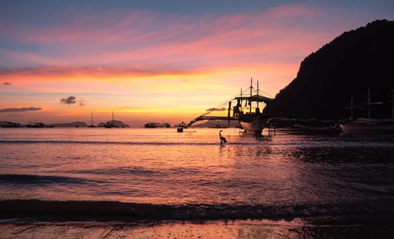 Beautiful sunset with silhouettes of philippine boat in El Nido, Palawan island, Philippines