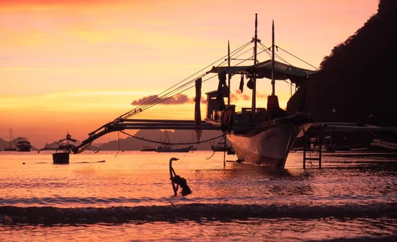 Beautiful sunset with silhouettes of philippine boat in El Nido, Palawan island, Philippines