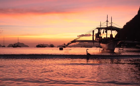 Beautiful sunset with silhouettes of philippine boat in El Nido, Palawan island, Philippines