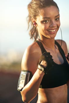 Woman, athlete or boxer in outdoor portrait for exercise, training and fitness with earphones. Female person, fists or fighter workout in nature with music playing for endurance, sports or cardio.