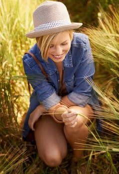 Woman, smile and peace in outdoor wheat field, spring and relax in sustainable nature. Female person, happy and travel to meadow on summer holiday or vacation, environment and trip to countryside.