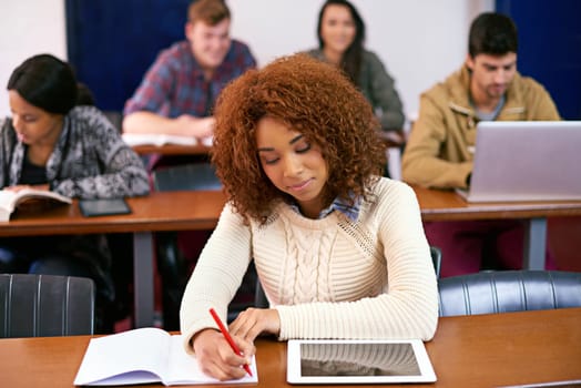 University, girl and writing with tablet in classroom for project, knowledge and research at campus. Education, book and student with technology at academy for learning, studying and scholarship.