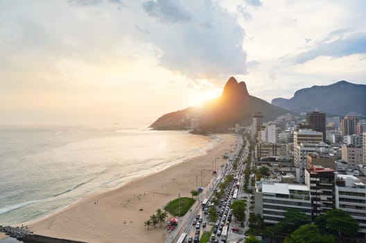 Drone, beach and city with sunshine, nature and travel with Rio de Janeiro, Brazil and vacation. Getaway trip, aerial view and outdoor with mountains, seaside and sand with buildings and vacation.